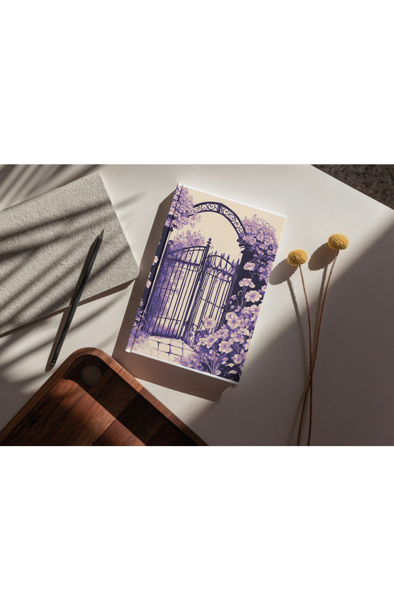 Garden-themed journal on table beside pencil